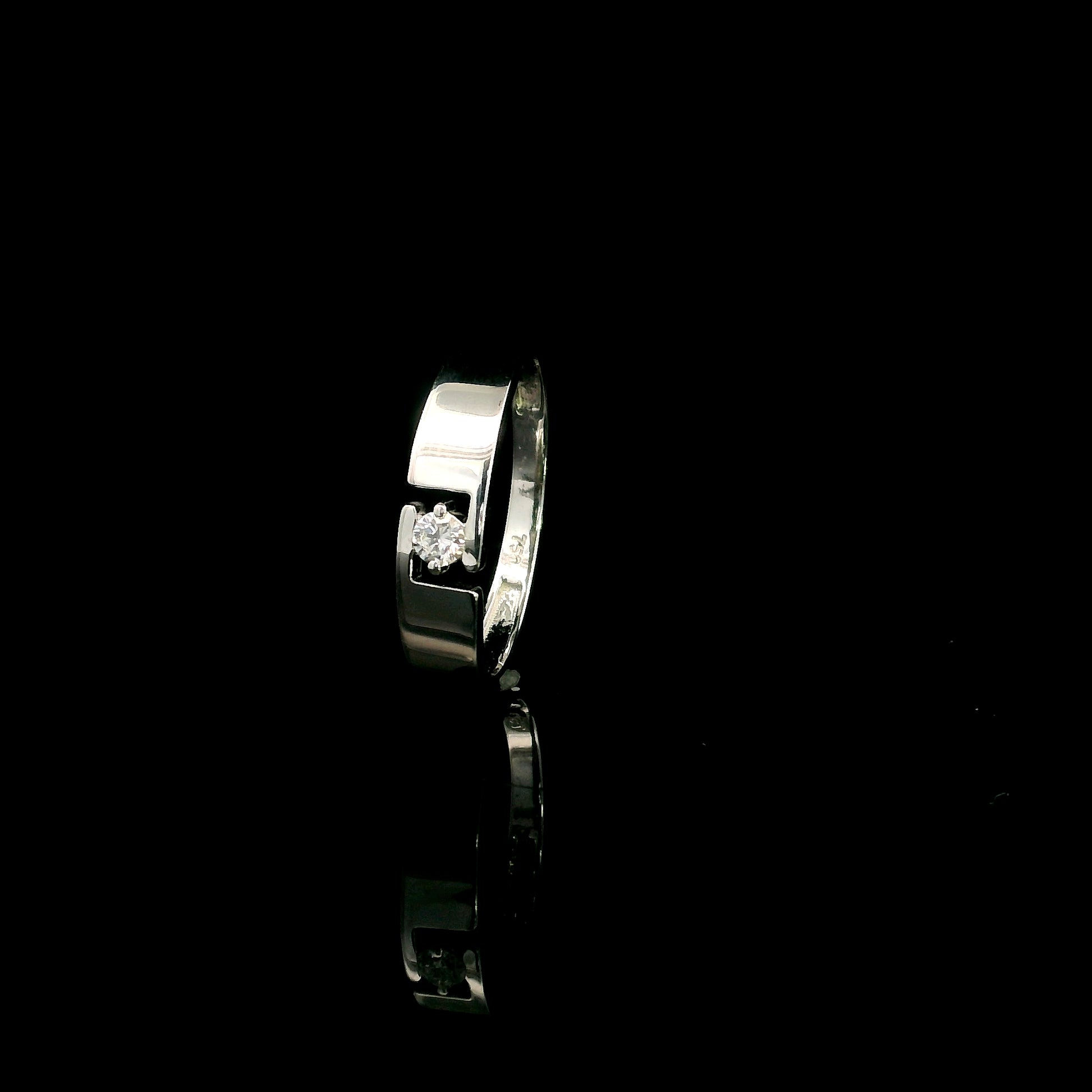 18K white gold floating diamond ring featuring a 0.08 carat natural round brilliant solitaire in a modern open band.