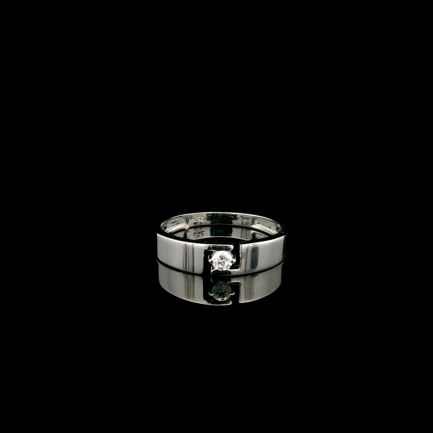 18K white gold floating diamond ring featuring a 0.08 carat natural round brilliant solitaire in a modern open band.