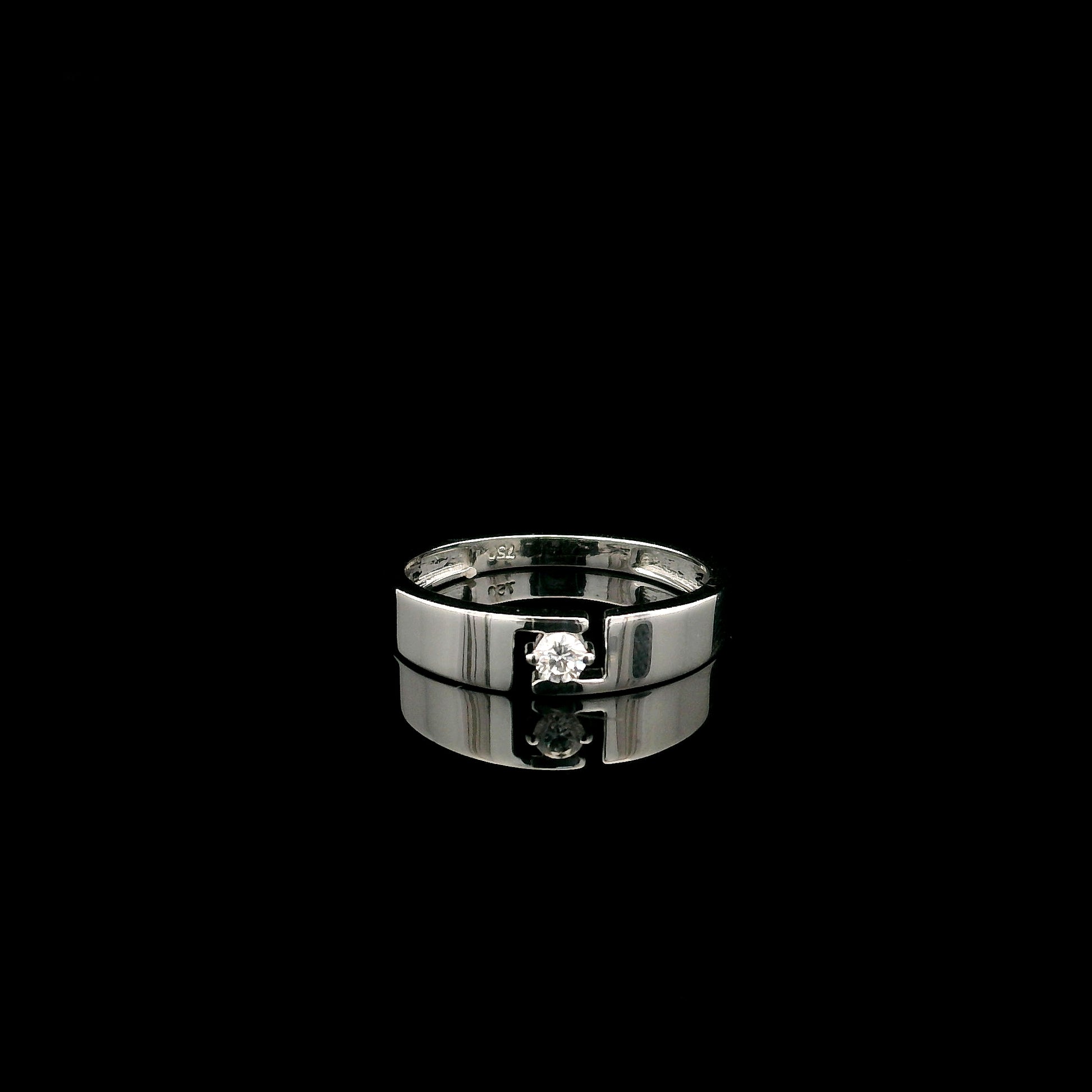 18K white gold floating diamond ring featuring a 0.08 carat natural round brilliant solitaire in a modern open band.