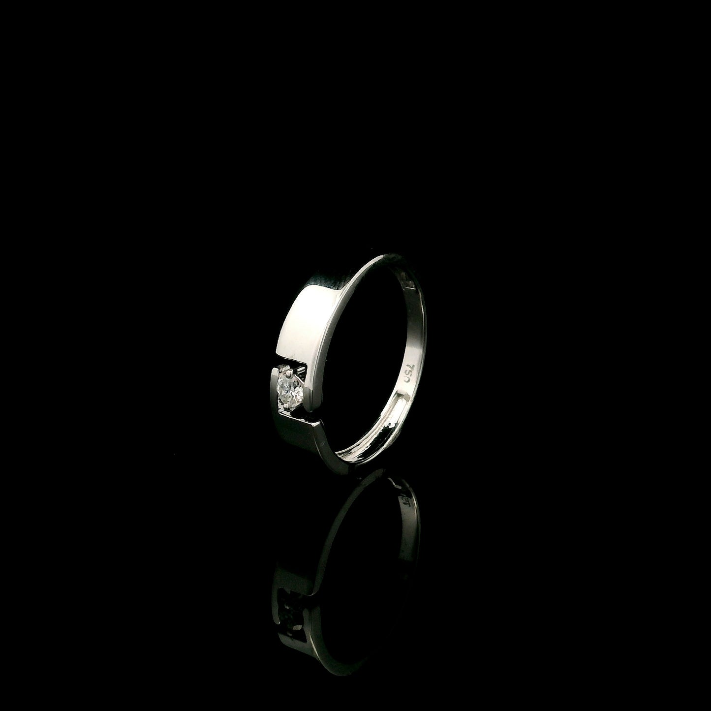 18K white gold floating diamond ring featuring a 0.08 carat natural round brilliant solitaire in a modern open band.