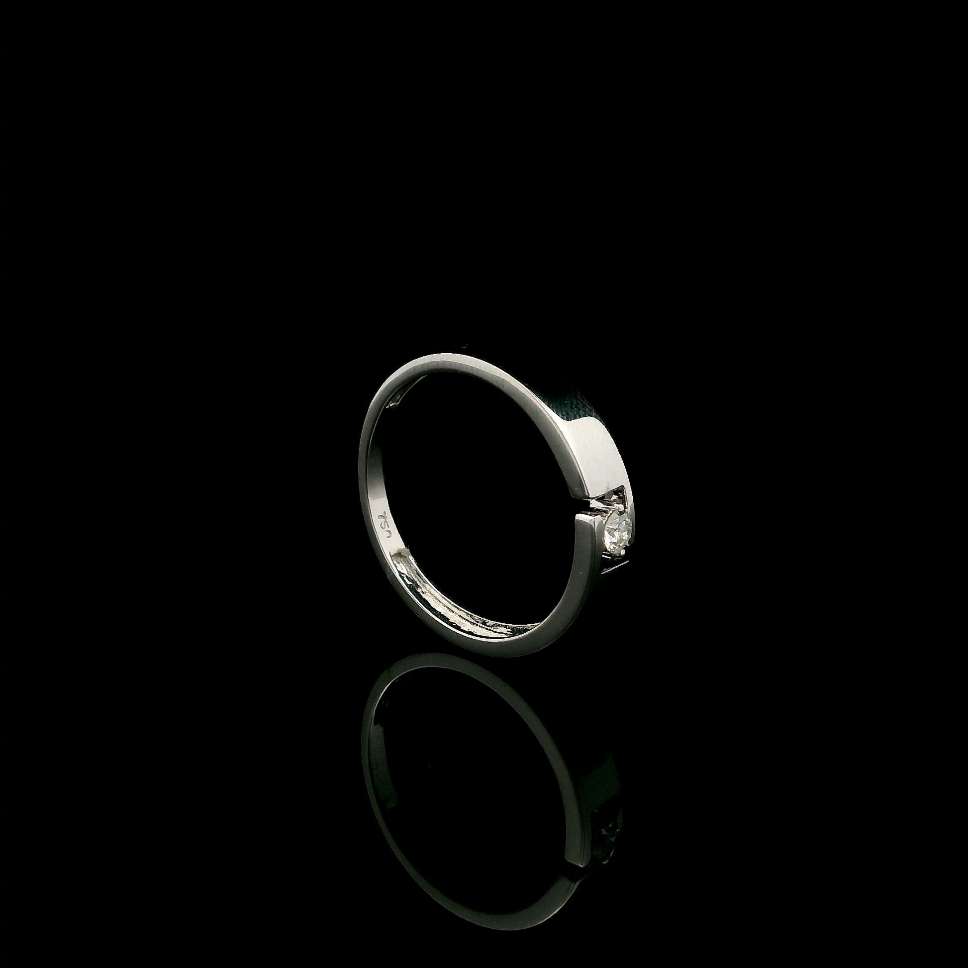 18K white gold floating diamond ring featuring a 0.08 carat natural round brilliant solitaire in a modern open band.