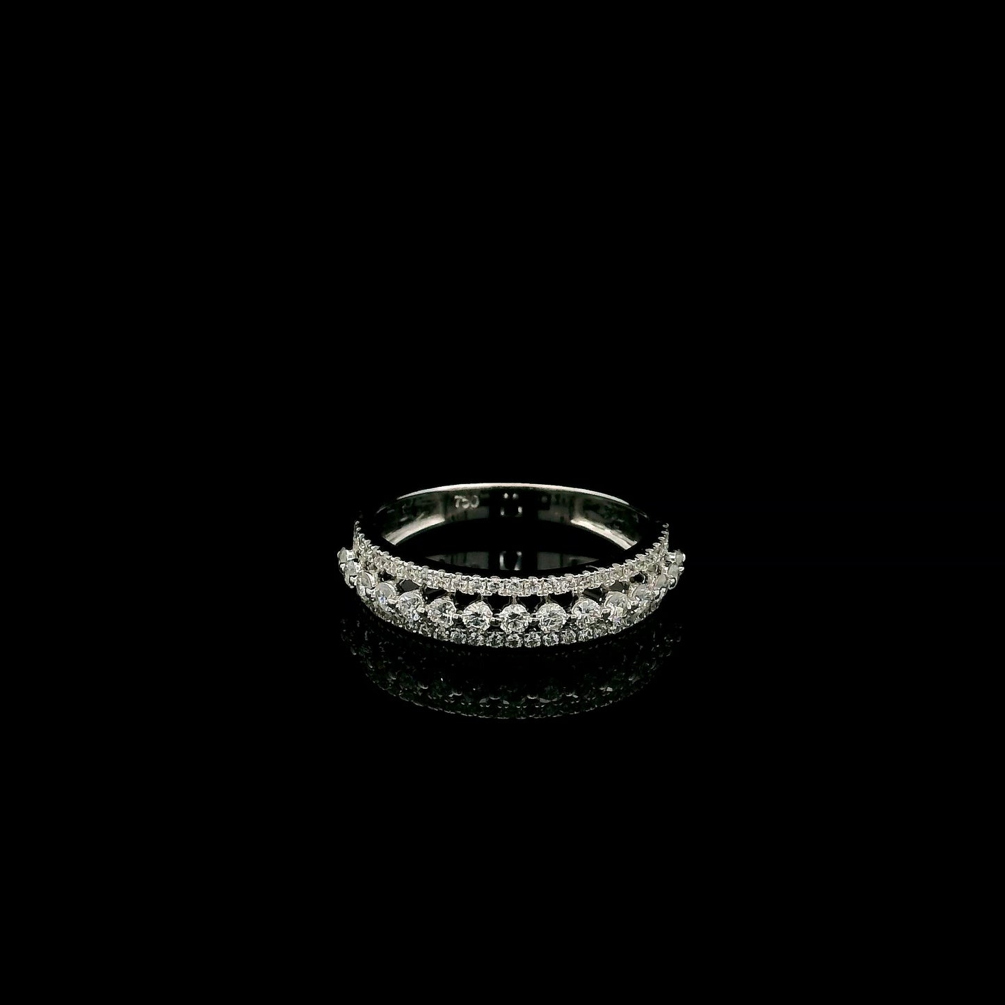 Natural three row diamond wedding band in solid 18K white gold featuring an elevated centre row of round brilliant diamonds with two pavé diamond rows, total diamond weight 0.62 carat.