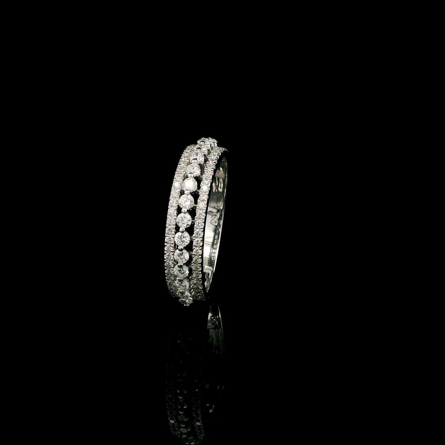 Natural three row diamond wedding band in solid 18K white gold featuring an elevated centre row of round brilliant diamonds with two pavé diamond rows, total diamond weight 0.62 carat.
