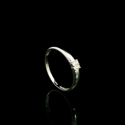 Minimalist natural diamond ring crafted in 18K white gold featuring a polished band with a four-diamond cluster.