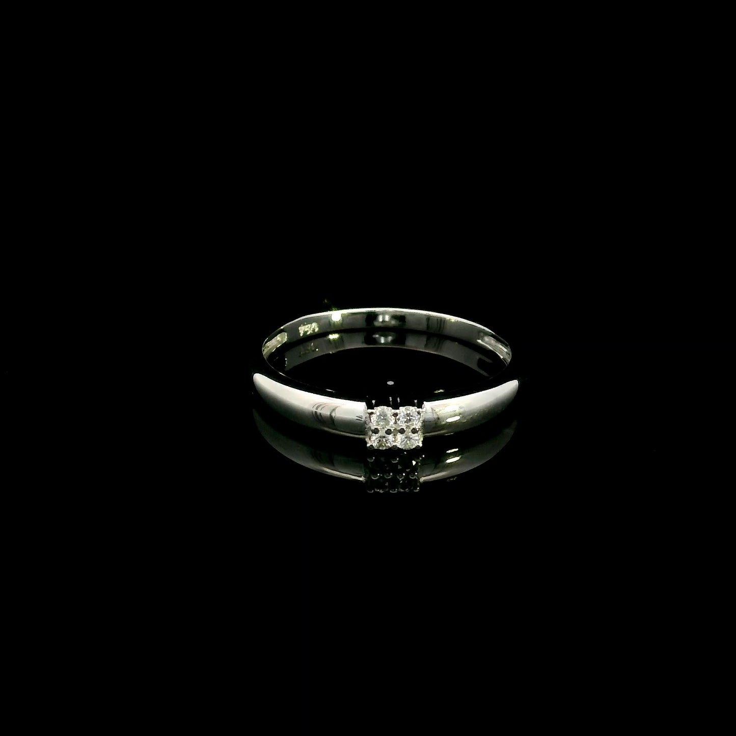 Minimalist natural diamond ring crafted in 18K white gold featuring a polished band with a four-diamond cluster.