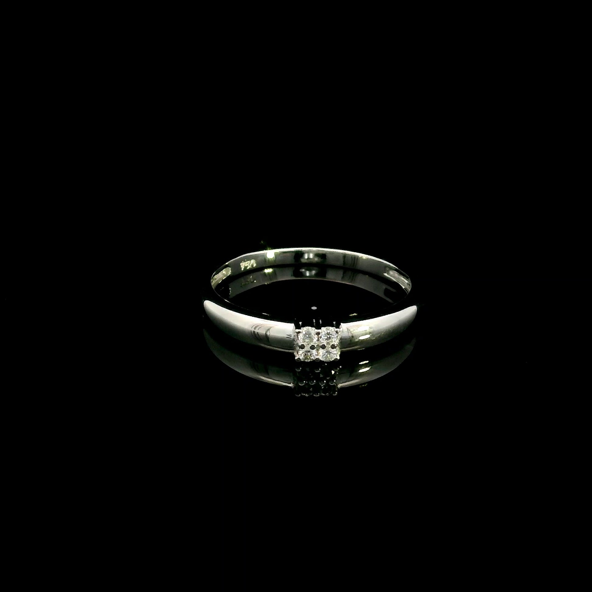 Minimalist natural diamond ring crafted in 18K white gold featuring a polished band with a four-diamond cluster.