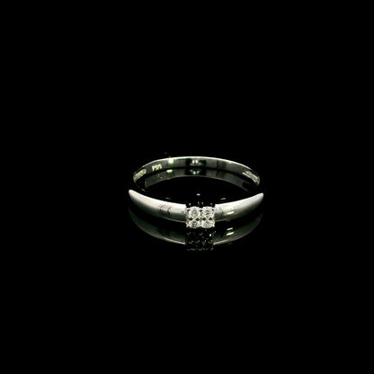 Minimalist natural diamond ring crafted in 18K white gold featuring a polished band with a four-diamond cluster.