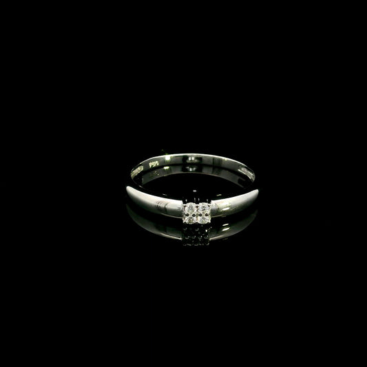 Minimalist natural diamond ring crafted in 18K white gold featuring a polished band with a four-diamond cluster.