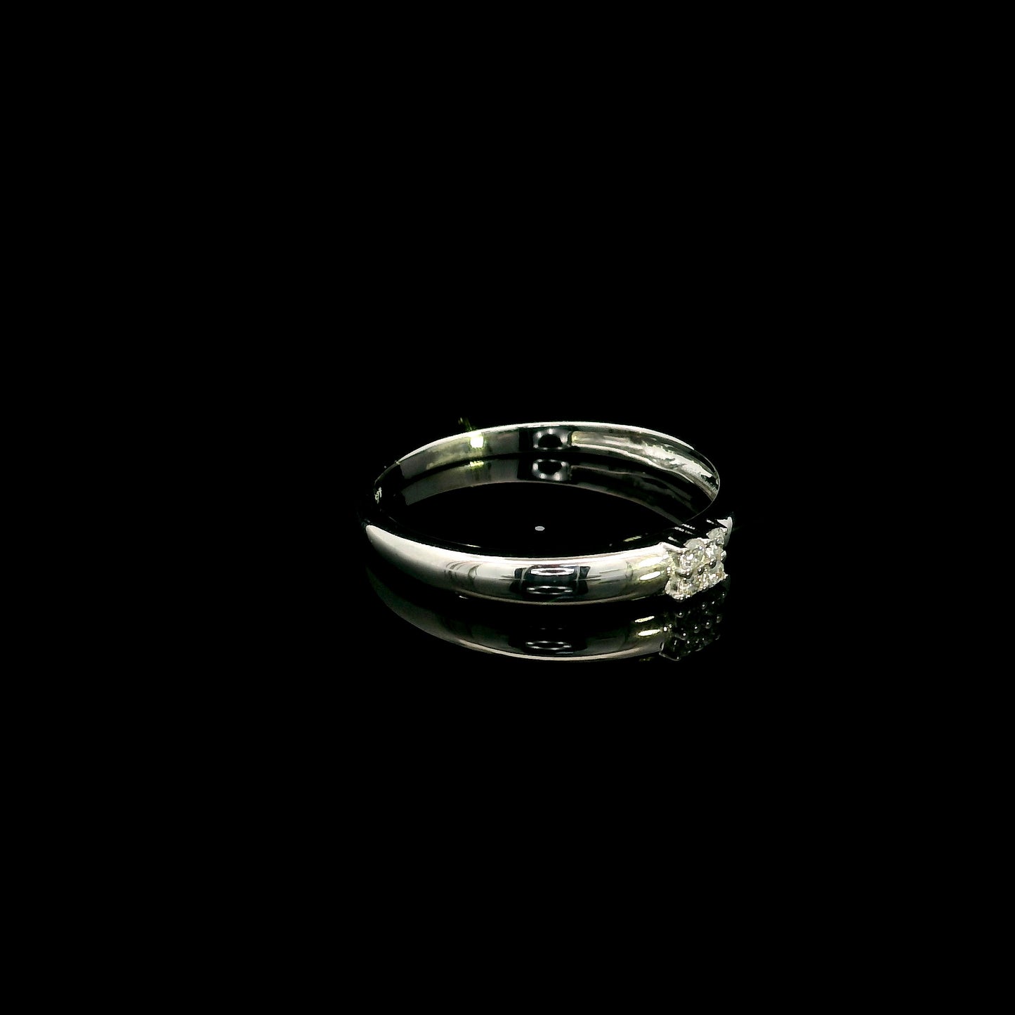 Minimalist natural diamond ring crafted in 18K white gold featuring a polished band with a four-diamond cluster.