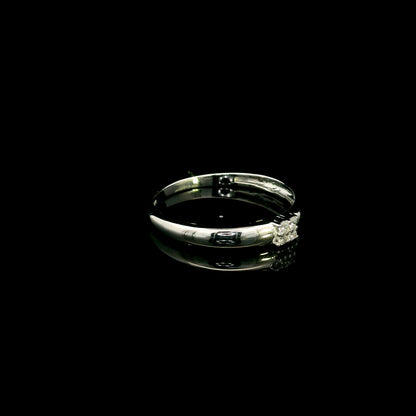 Minimalist natural diamond ring crafted in 18K white gold featuring a polished band with a four-diamond cluster.
