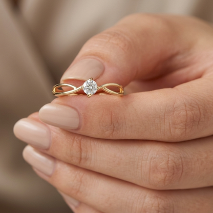 18K yellow gold twist solitaire ring featuring a 0.16 carat natural round brilliant diamond in a four-prong setting.