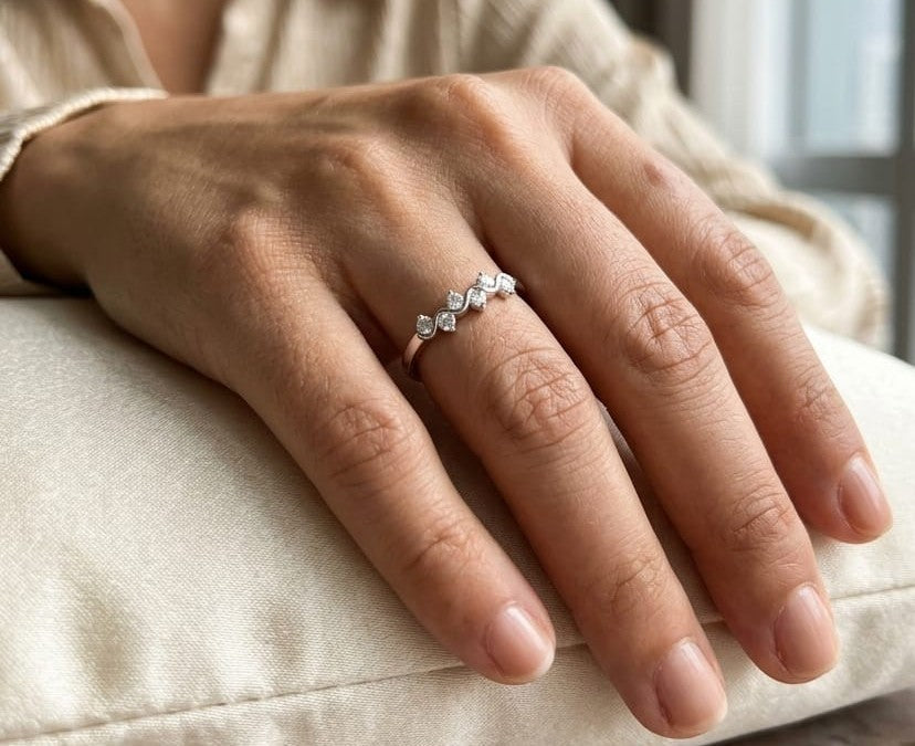 18K white gold diamond stack ring featuring natural round brilliant diamonds totaling 0.23 carat in a flowing shared prong design.