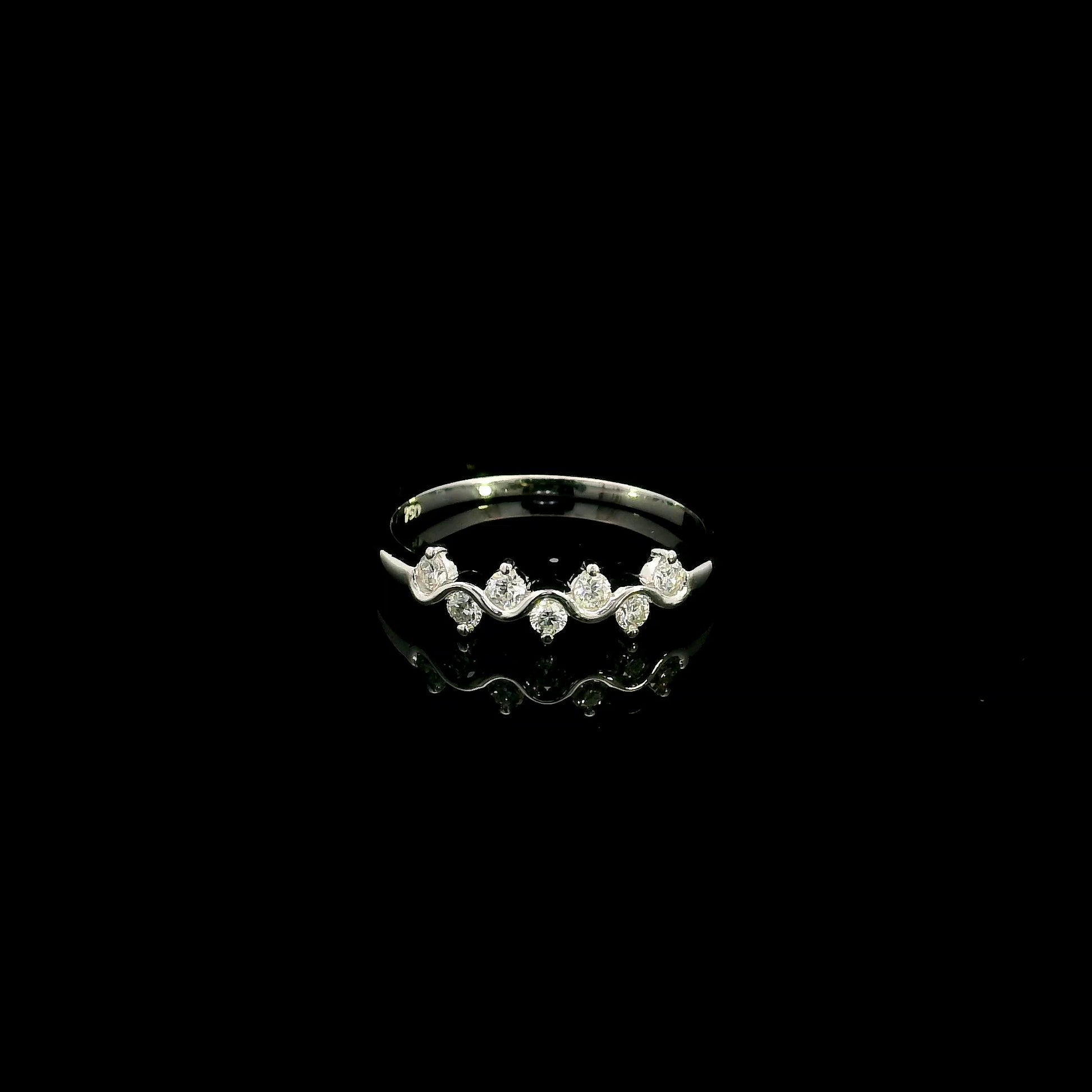 18K white gold diamond stack ring featuring natural round brilliant diamonds totaling 0.23 carat in a flowing shared prong design.