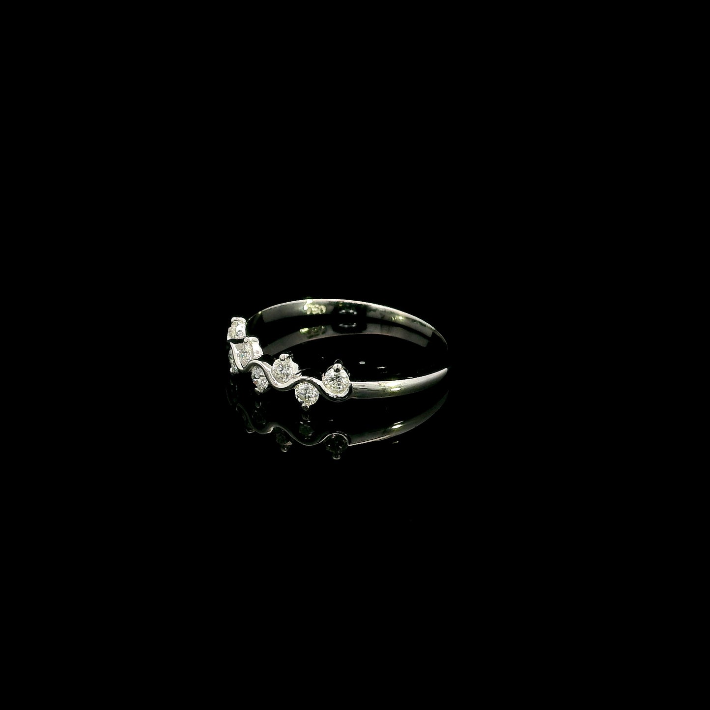 18K white gold diamond stack ring featuring natural round brilliant diamonds totaling 0.23 carat in a flowing shared prong design.
