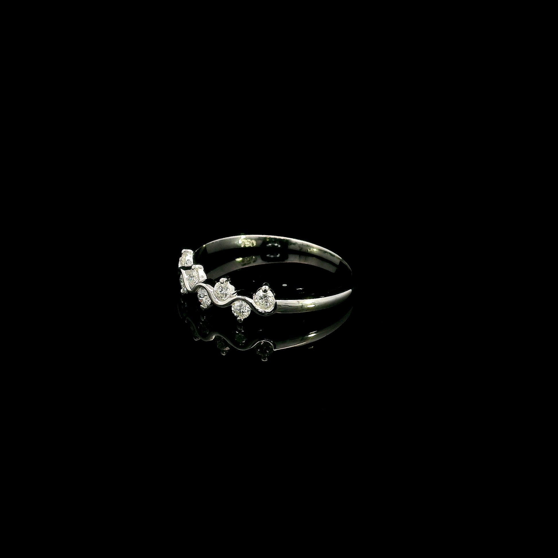 18K white gold diamond stack ring featuring natural round brilliant diamonds totaling 0.23 carat in a flowing shared prong design.