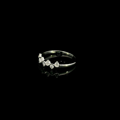 18K white gold diamond stack ring featuring natural round brilliant diamonds totaling 0.23 carat in a flowing shared prong design.