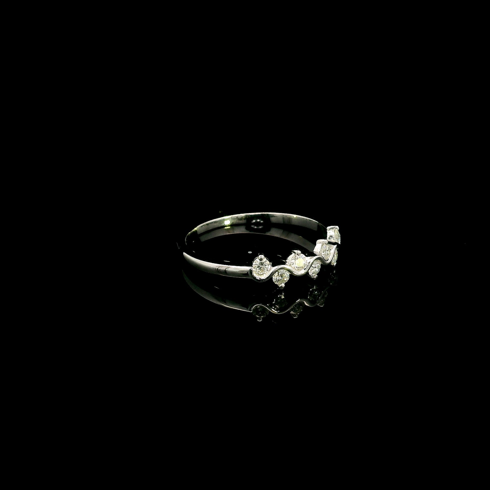 18K white gold diamond stack ring featuring natural round brilliant diamonds totaling 0.23 carat in a flowing shared prong design.