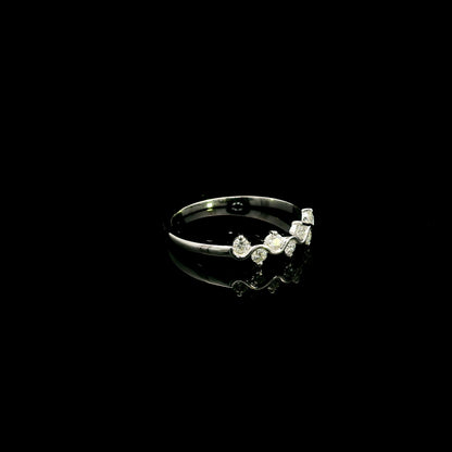 18K white gold diamond stack ring featuring natural round brilliant diamonds totaling 0.23 carat in a flowing shared prong design.