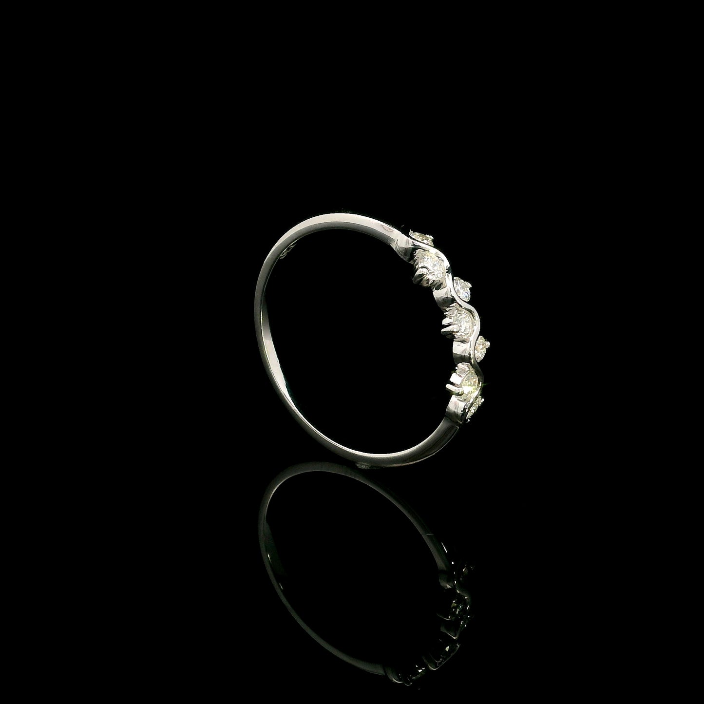 18K white gold diamond stack ring featuring natural round brilliant diamonds totaling 0.23 carat in a flowing shared prong design.