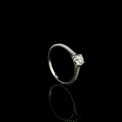 18K white gold round brilliant diamond solitaire engagement ring featuring a 0.51 carat GIA certified natural diamond with a pavé diamond band.