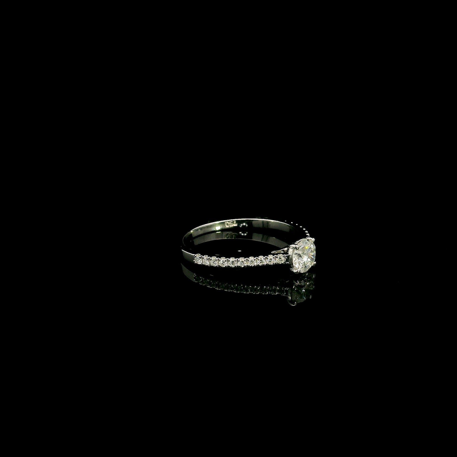 18K white gold round brilliant diamond solitaire engagement ring featuring a 0.51 carat GIA certified natural diamond with a pavé diamond band.