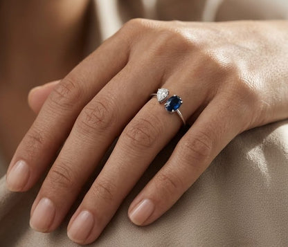 18K white gold blue sapphire diamond open ring featuring a 1.07 Carat natural oval sapphire with a pear-shaped natural diamond cluster.