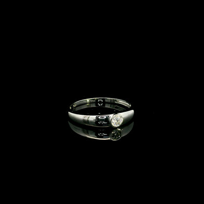 18K white gold bezel set solitaire diamond ring featuring a 0.11 carat natural round brilliant diamond with a smooth polished band.