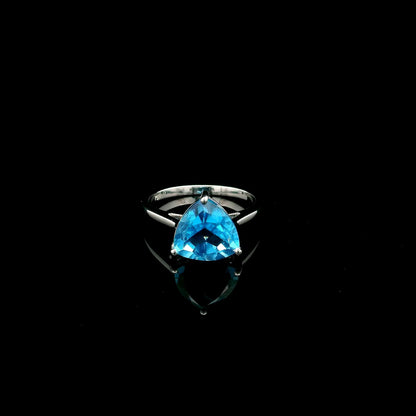 18K white gold solitaire ring featuring a 4.57 carat natural trillion-cut blue topaz in a contemporary three-prong setting.