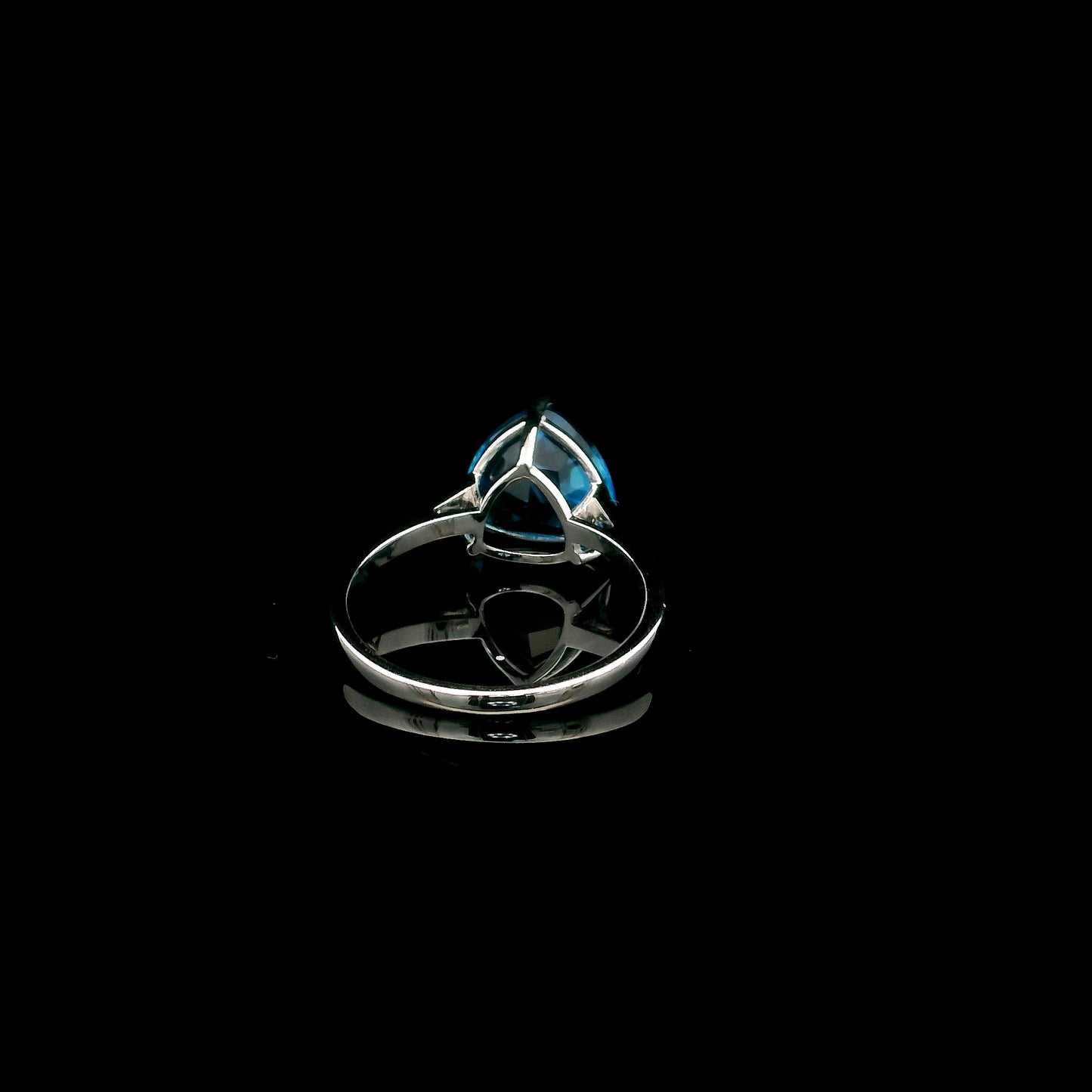 18K white gold solitaire ring featuring a 4.57 carat natural trillion-cut blue topaz in a contemporary three-prong setting.