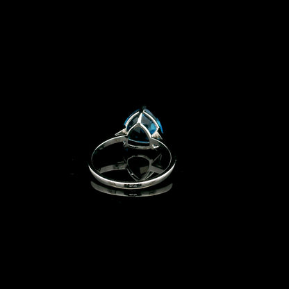 18K white gold solitaire ring featuring a 4.57 carat natural trillion-cut blue topaz in a contemporary three-prong setting.