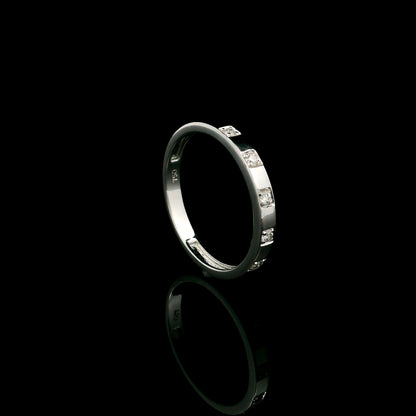 18K white gold diamond wedding band featuring five natural round brilliant diamonds in a modern flush-style polished band.