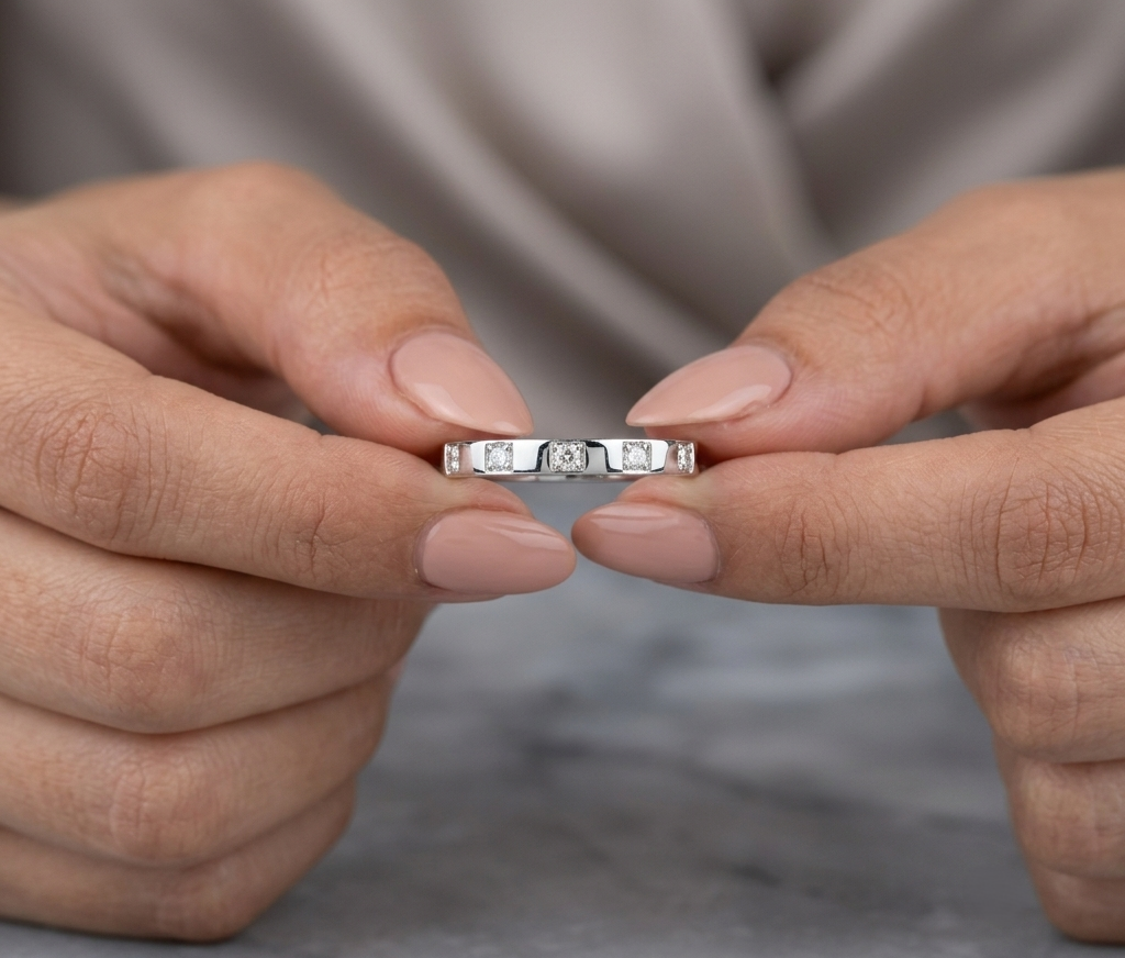 18K white gold diamond wedding band featuring five natural round brilliant diamonds in a modern flush-style polished band.