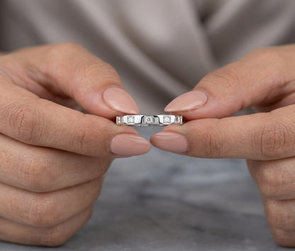 18K white gold diamond wedding band featuring five natural round brilliant diamonds in a modern flush-style polished band.