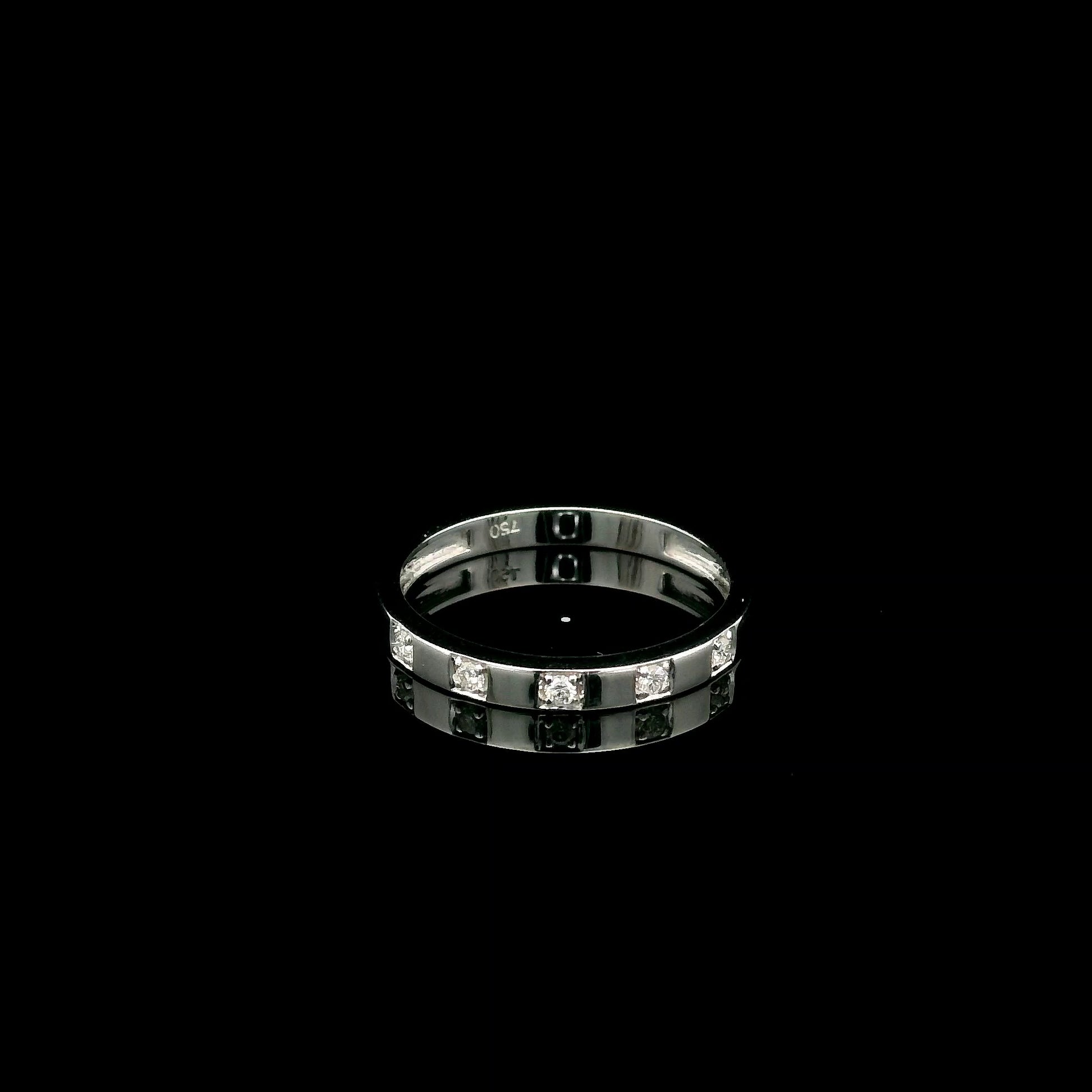 18K white gold diamond wedding band featuring five natural round brilliant diamonds in a modern flush-style polished band.