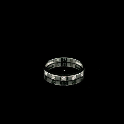 18K white gold diamond wedding band featuring five natural round brilliant diamonds in a modern flush-style polished band.