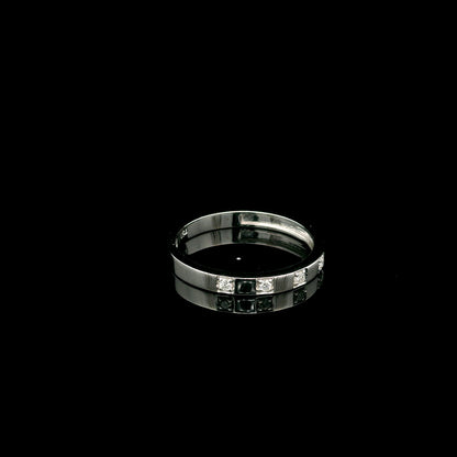 18K white gold diamond wedding band featuring five natural round brilliant diamonds in a modern flush-style polished band.