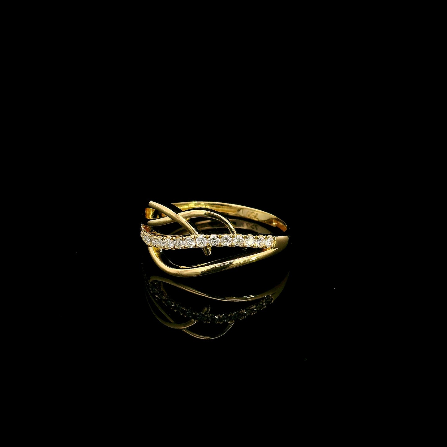 18K yellow gold interwoven diamond ring featuring flowing crossover bands and 0.22 carats of natural round brilliant diamonds.