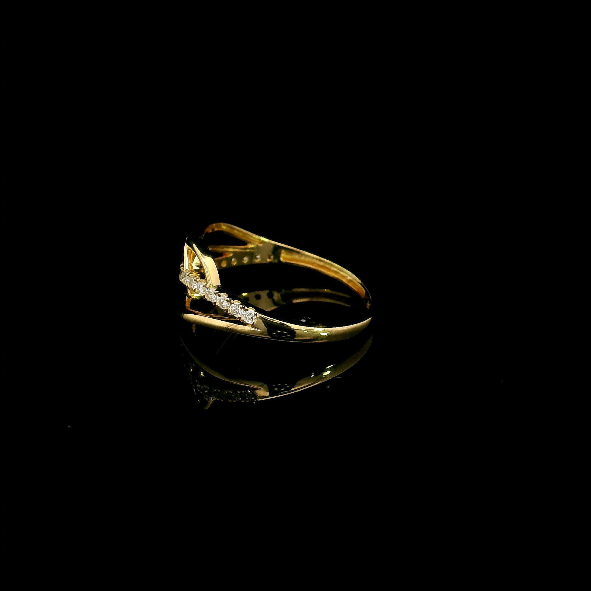 18K yellow gold interwoven diamond ring featuring flowing crossover bands and 0.22 carats of natural round brilliant diamonds.
