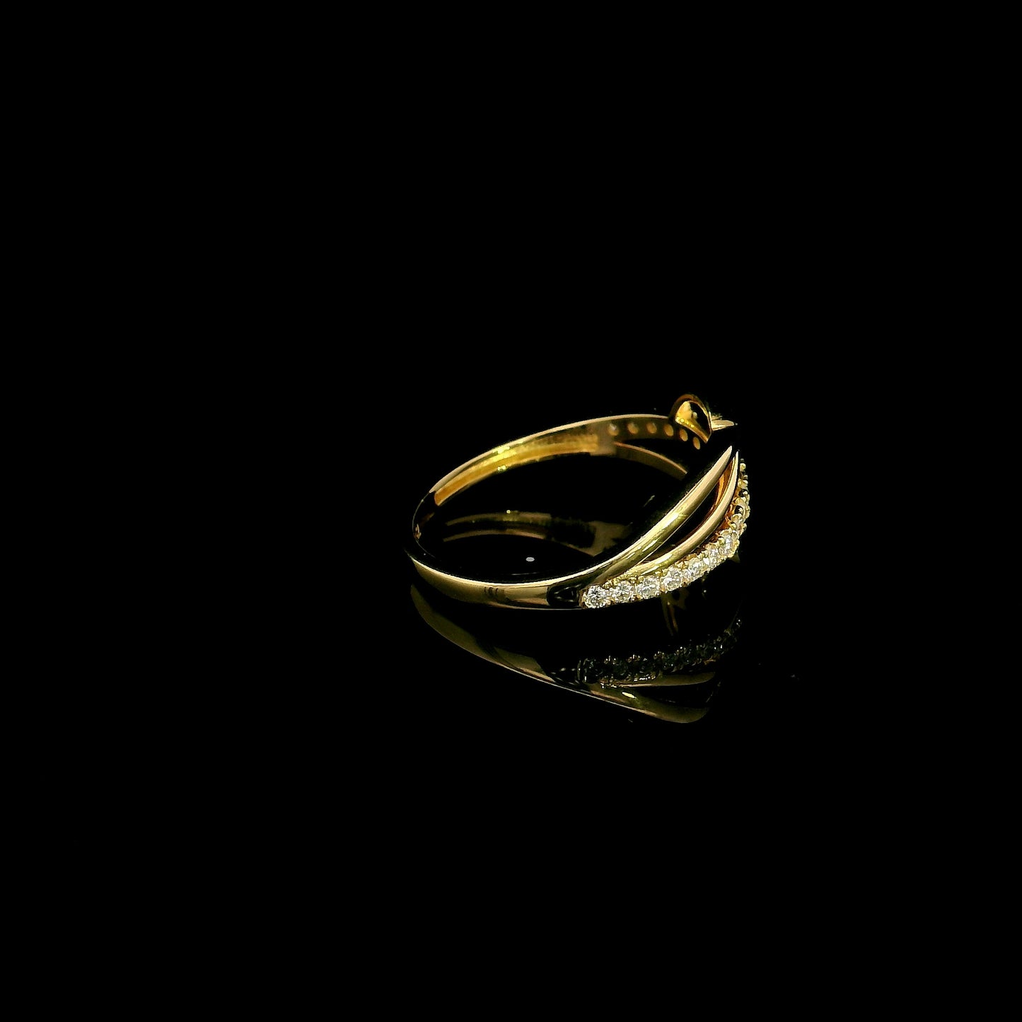 18K yellow gold interwoven diamond ring featuring flowing crossover bands and 0.22 carats of natural round brilliant diamonds.