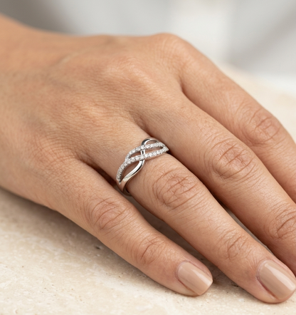 18K white gold diamond crossover ring featuring an elegant flowing design with 0.39 carat natural pavé-set diamonds.
