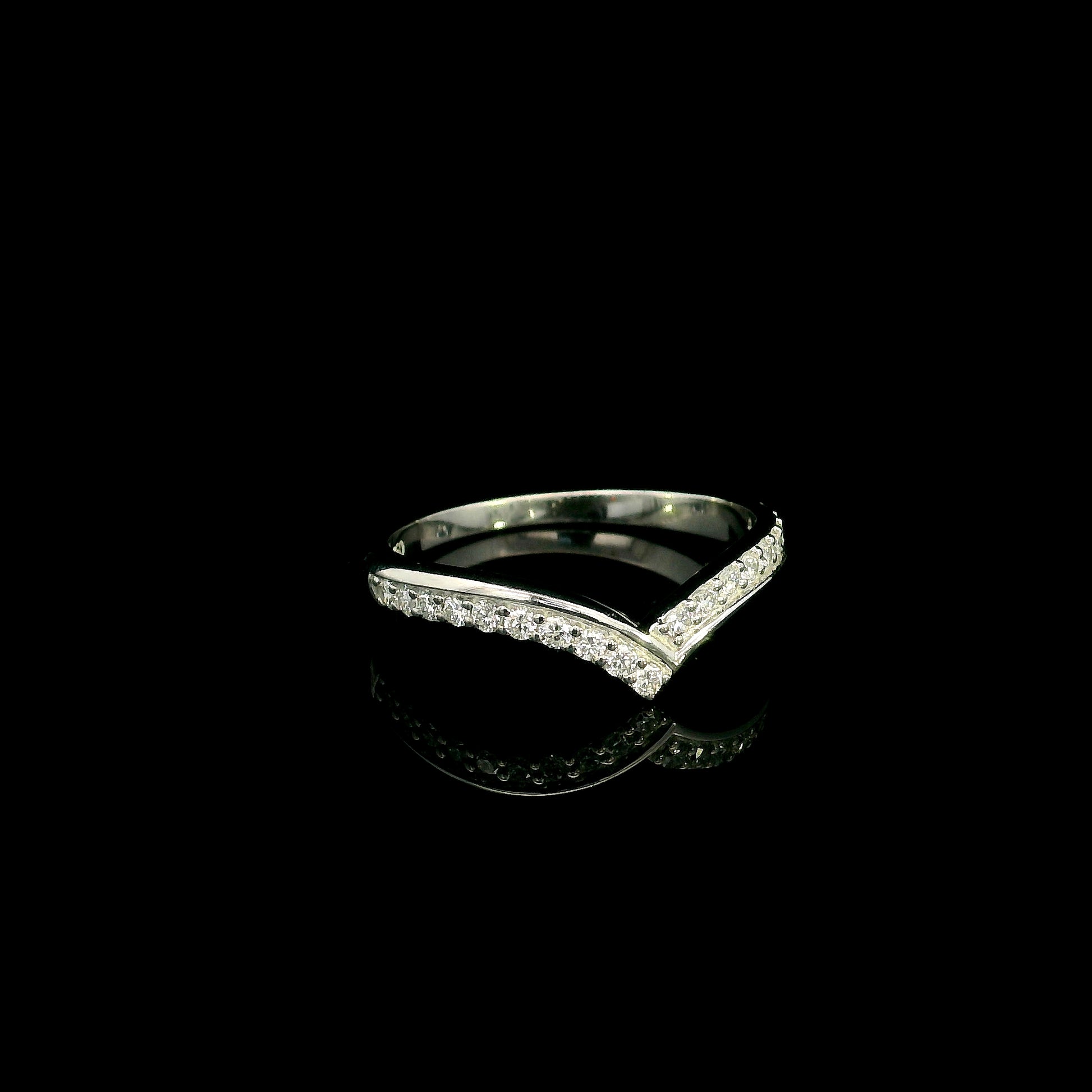 18K white gold chevron diamond wedding band featuring 0.27 carat natural round brilliant diamonds in a pavé setting.