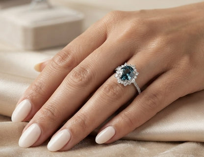 18K white gold London Blue Topaz halo ring featuring a 2.04 Carat round natural topaz surrounded by a sparkling natural diamond halo.