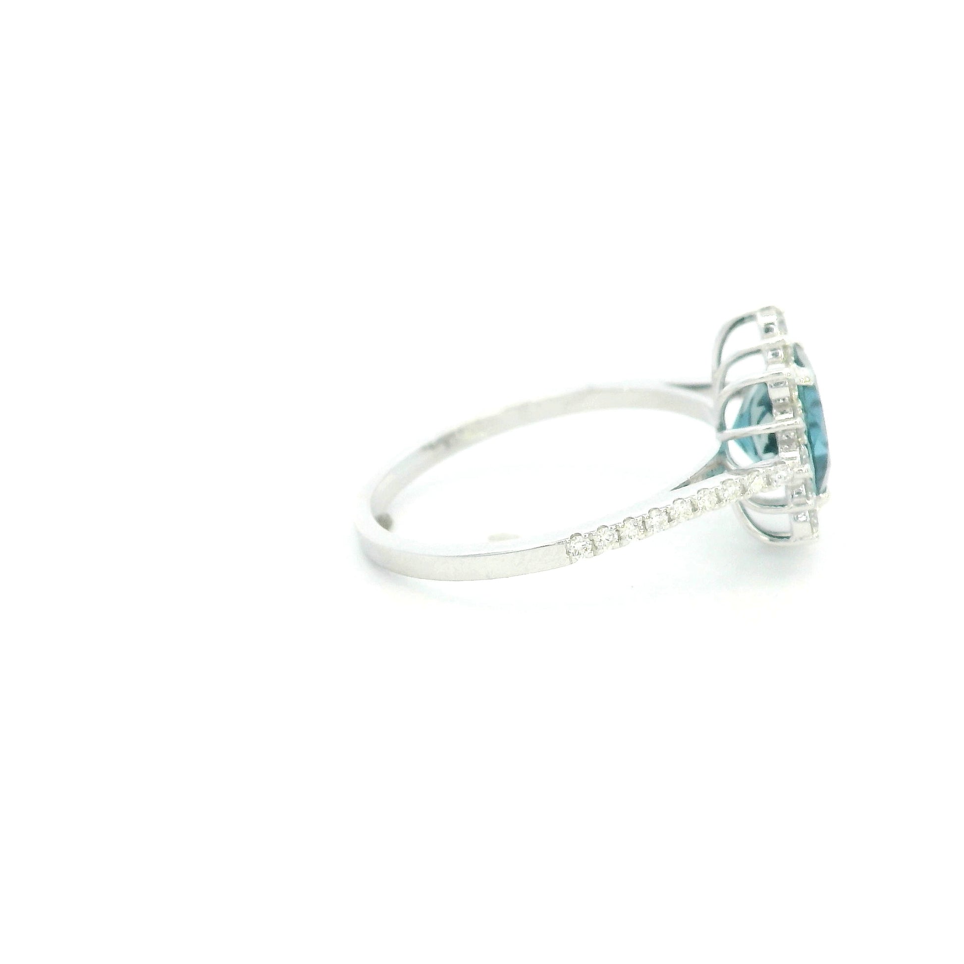 18K white gold London Blue Topaz halo ring featuring a 2.04 Carat round natural topaz surrounded by a sparkling natural diamond halo.