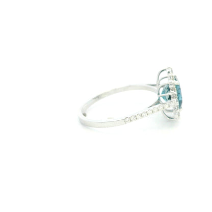 18K white gold London Blue Topaz halo ring featuring a 2.04 Carat round natural topaz surrounded by a sparkling natural diamond halo.