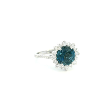 18K white gold London Blue Topaz halo ring featuring a 2.04 Carat round natural topaz surrounded by a sparkling natural diamond halo.