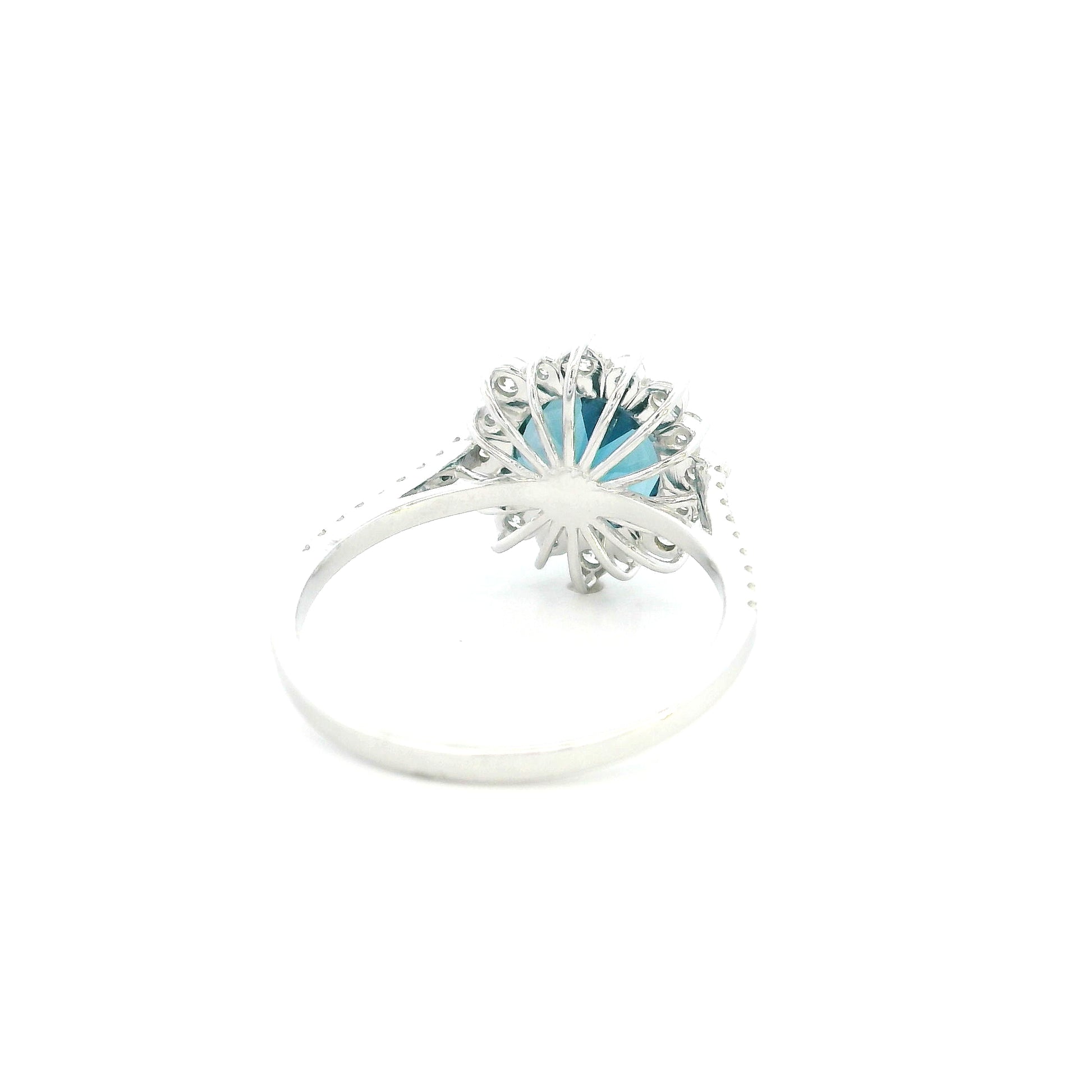 18K white gold London Blue Topaz halo ring featuring a 2.04 Carat round natural topaz surrounded by a sparkling natural diamond halo.