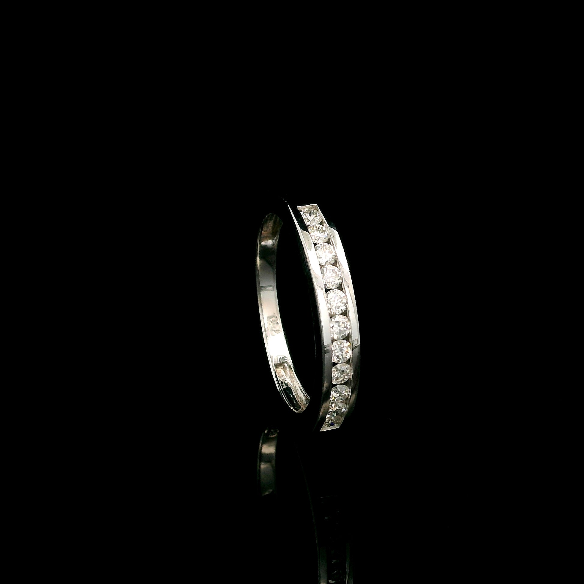 18K white gold channel set diamond wedding band featuring 0.36 carat natural round brilliant diamonds in a sleek polished stackable ring design.