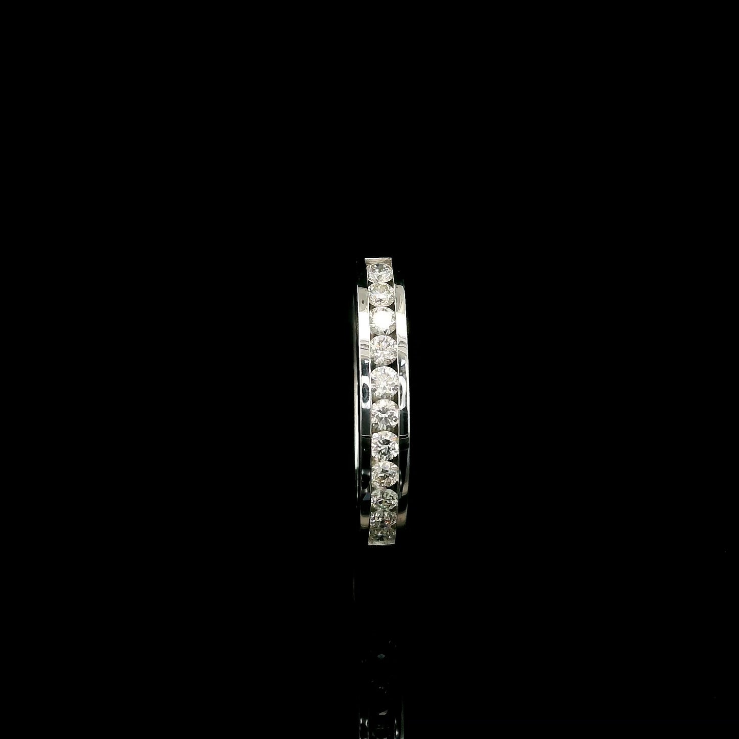 18K white gold channel set diamond wedding band featuring 0.36 carat natural round brilliant diamonds in a sleek polished stackable ring design.