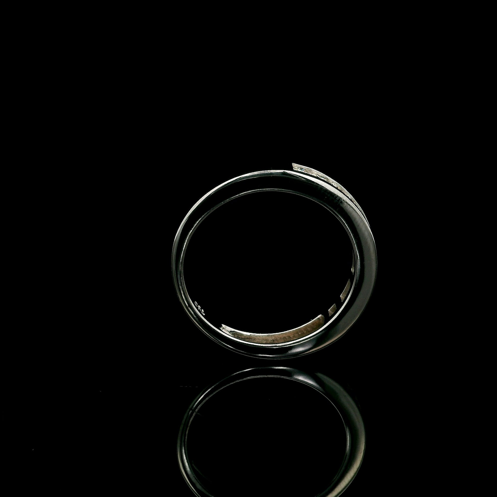 18K white gold channel set diamond wedding band featuring 0.36 carat natural round brilliant diamonds in a sleek polished stackable ring design.