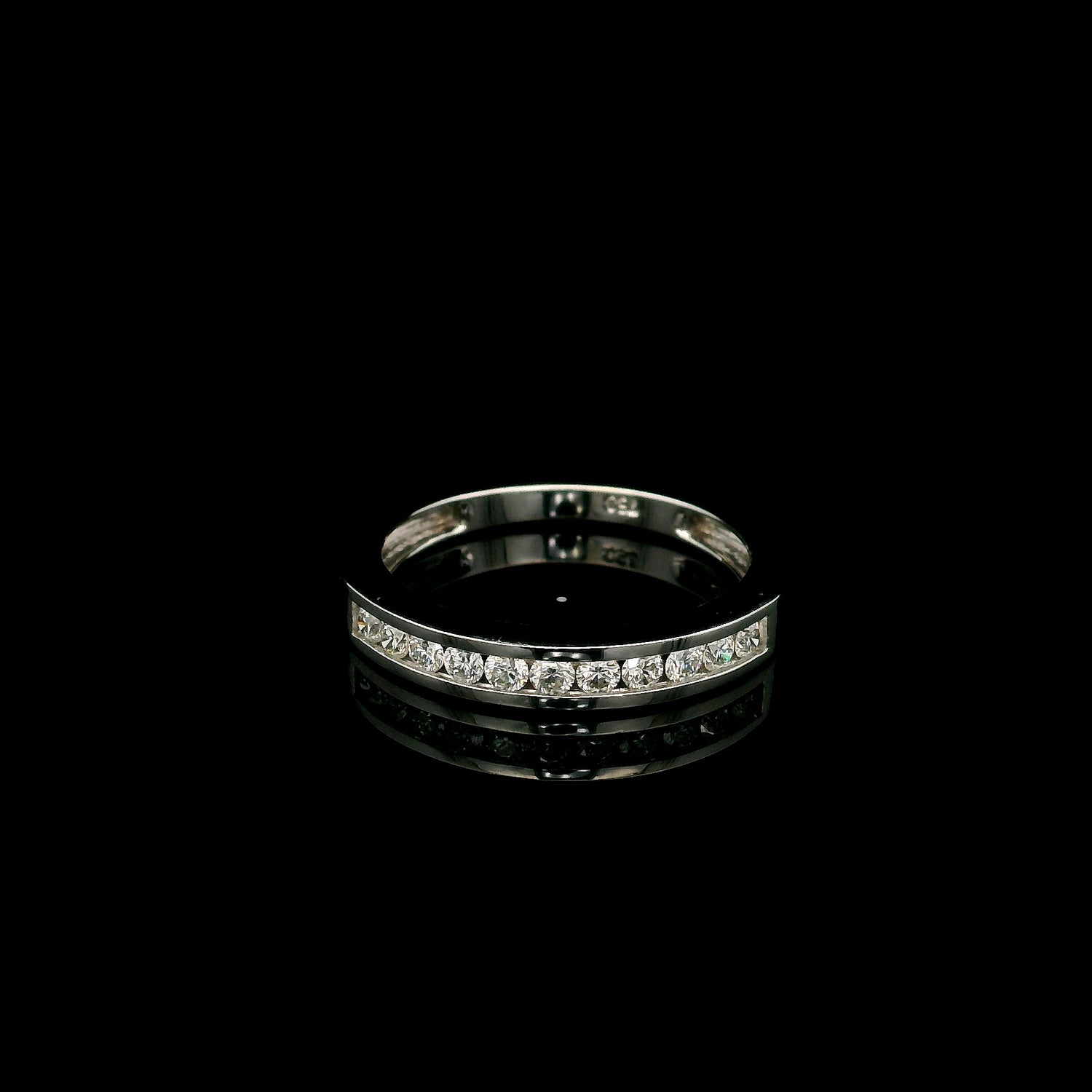 18K white gold channel set diamond wedding band featuring 0.36 carat natural round brilliant diamonds in a sleek polished stackable ring design.